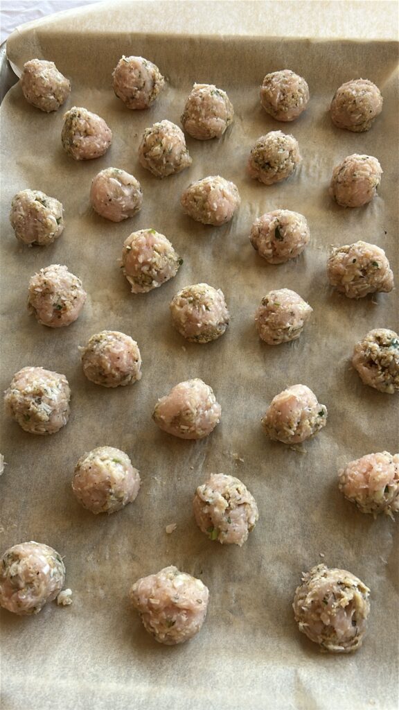 rolling mini turkey meatballs for italian wedding soup