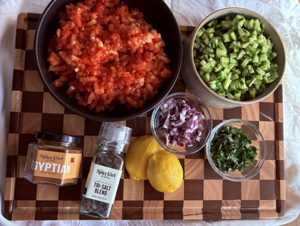 ingredients for salata baladi egyptian salad including tomatoes cucumbers parsley and lemon