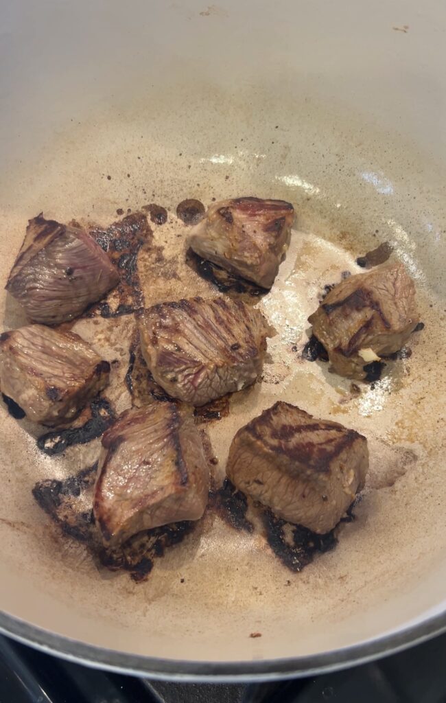 Searing beef for carne guisada in a Dutch oven