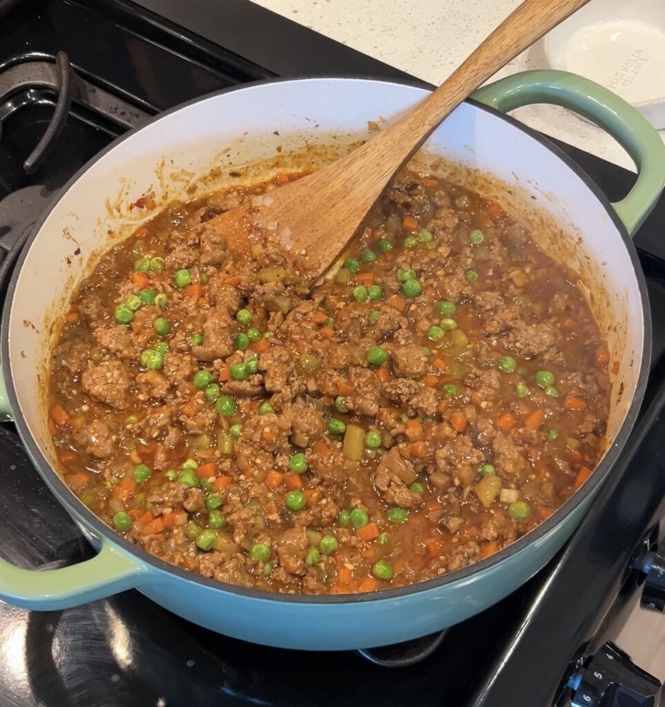 Shepherd’s pie filling simmering into a rich gravy