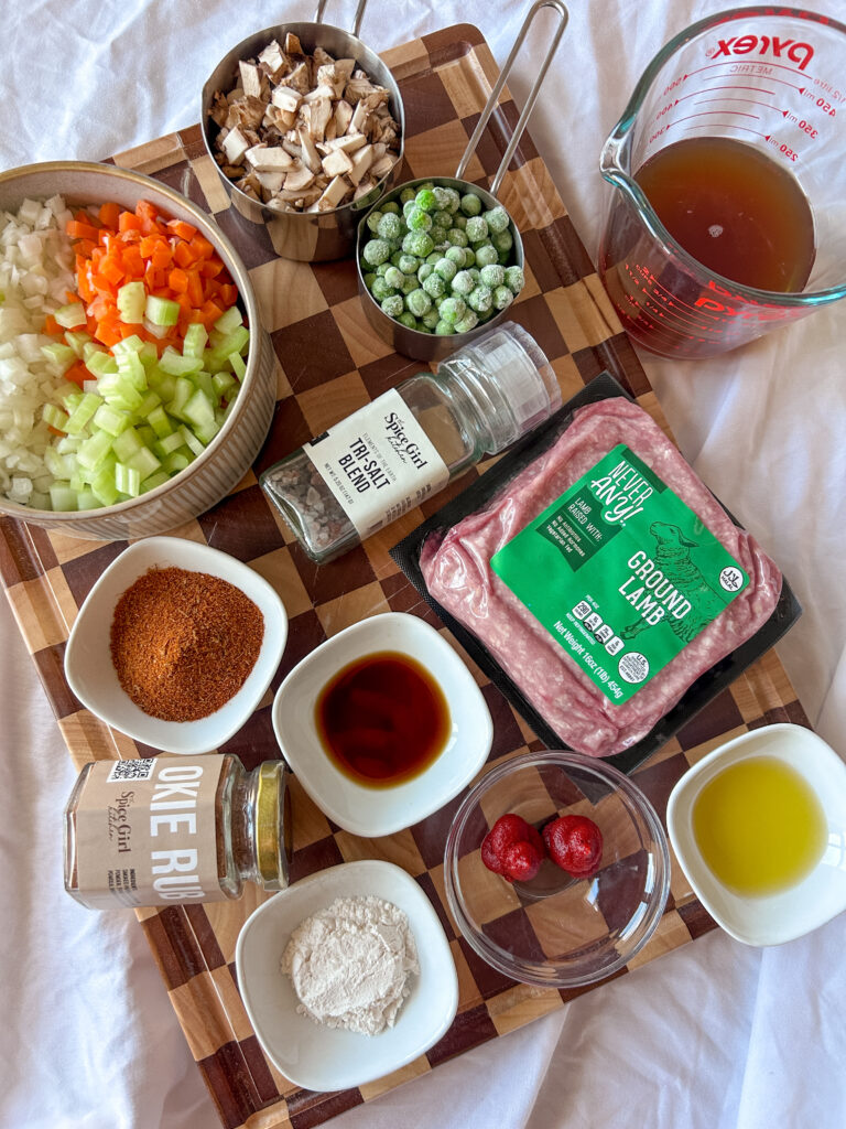 Ingredients for shepherd’s pie filling including lamb, vegetables, and seasoning