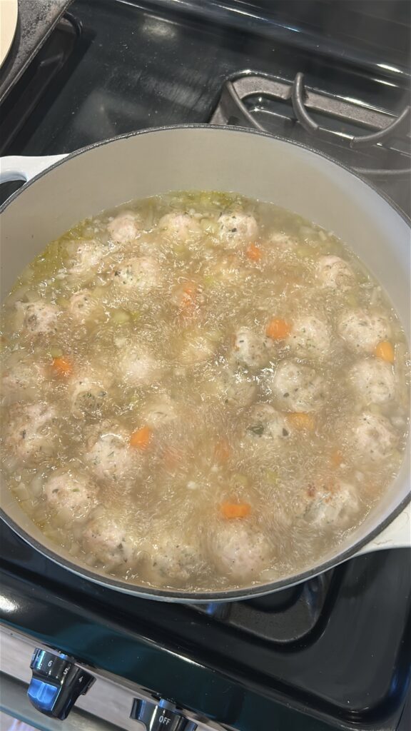turkey meatballs simmering in broth for italian wedding soup