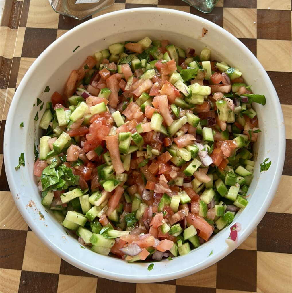 mixing salata baladi egyptian salad with lemon dressing