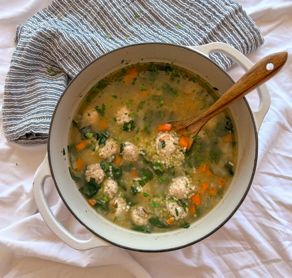 Spoonful of turkey meatball Italian wedding soup with pasta and spinach