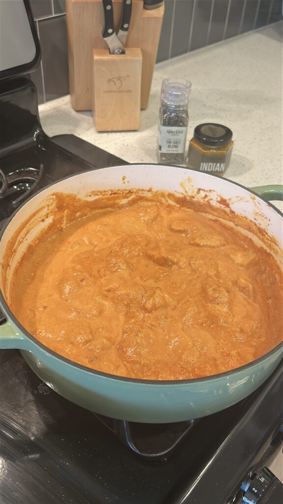 Adding cream to chicken tikka masala sauce for richness