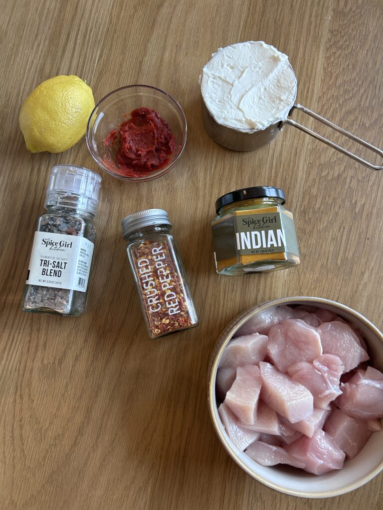 Ingredients for chicken tikka masala marinade with yogurt, tomato paste, and spices
