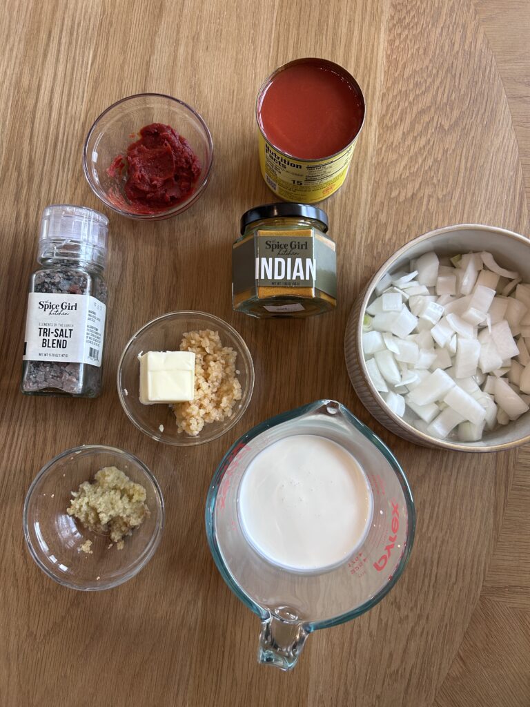 Ingredients for chicken tikka masala sauce including onion, garlic, ginger, and tomato