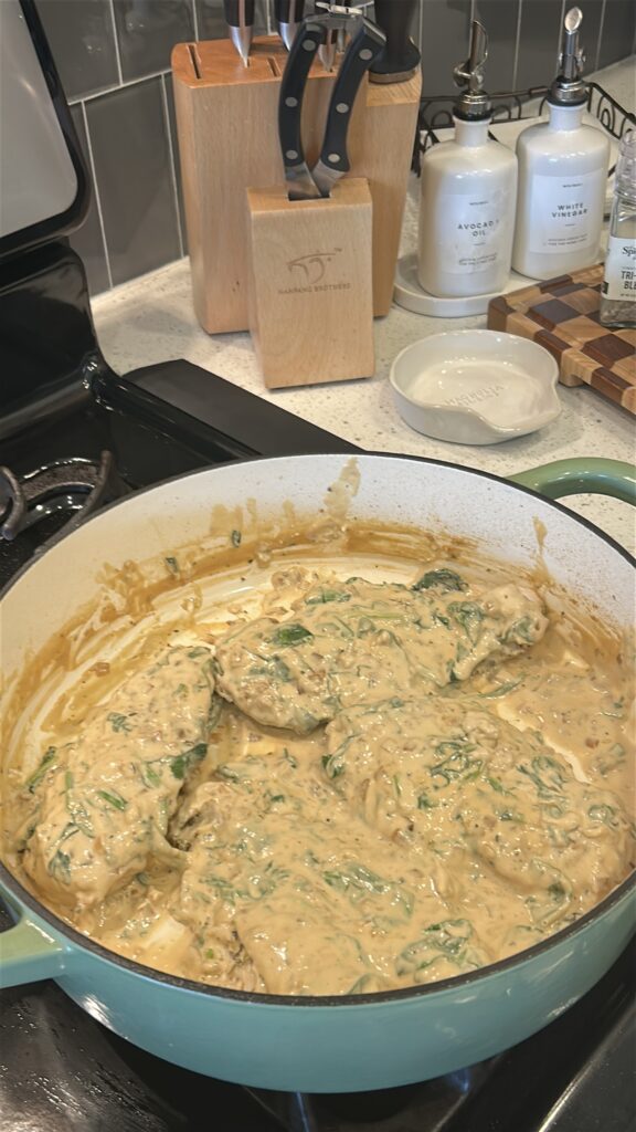 finishing creamy boursin chicken in skillet