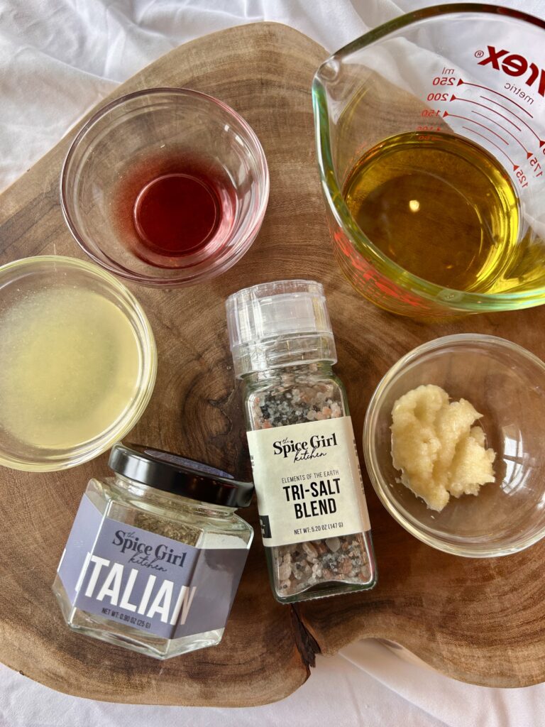 Ingredients for Italian chicken marinade including olive oil, lemon juice, garlic, and seasoning