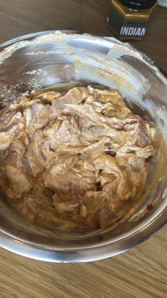 Chicken marinating in yogurt and spices for tikka masala