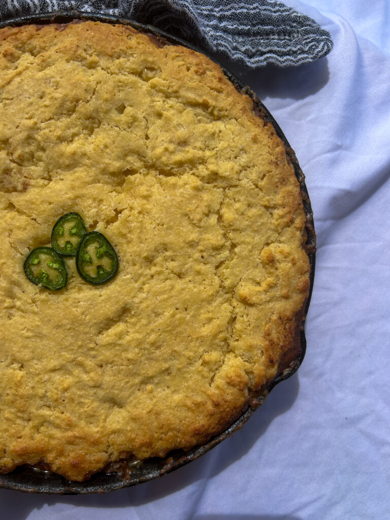 mexican cornbread casserole with ground beef and cheesy filling