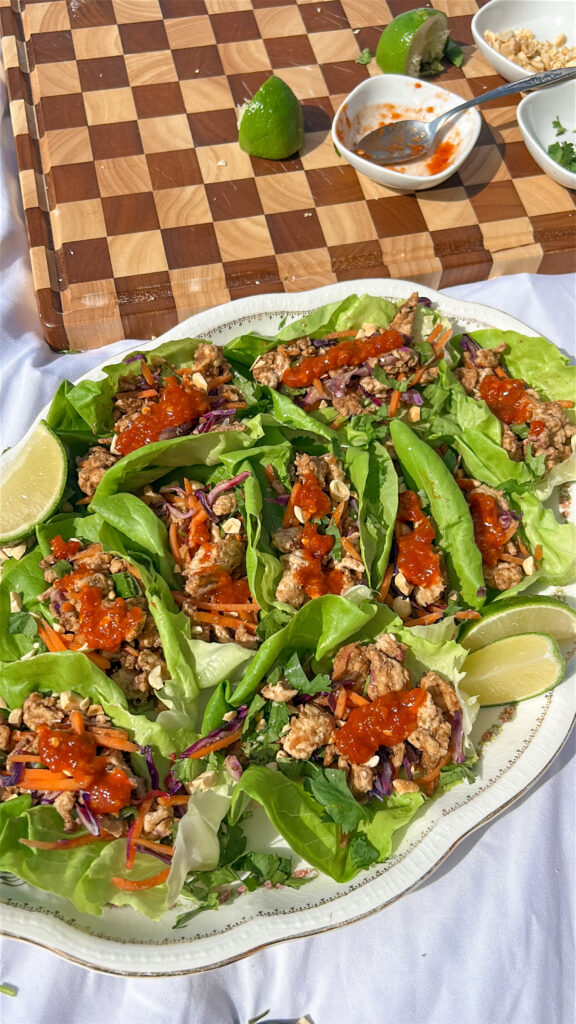 assembling Thai chicken lettuce wraps with fresh toppings