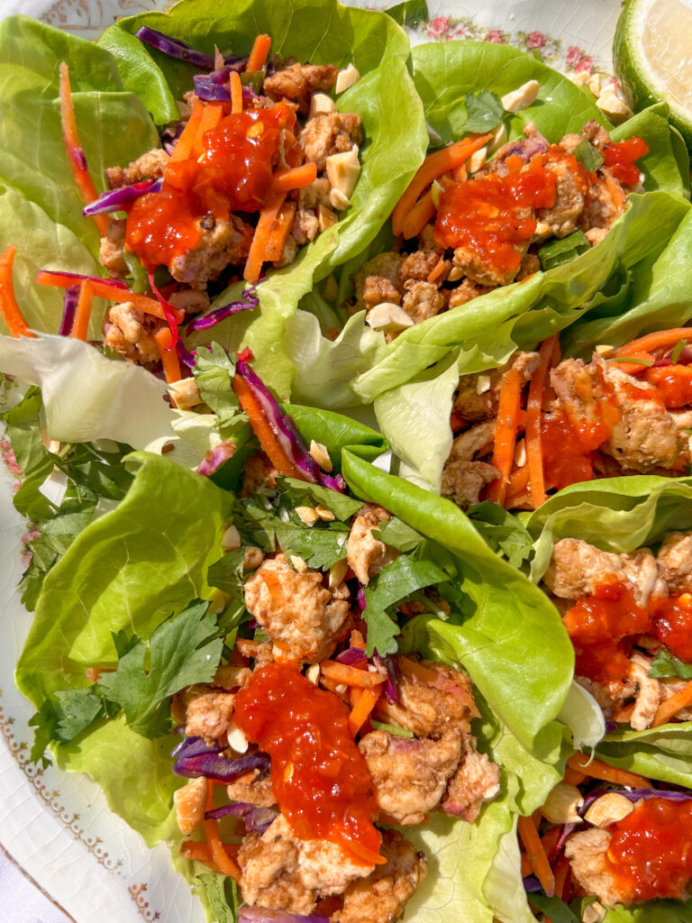close up of Thai chicken lettuce wraps with peanut flavor and fresh herbs