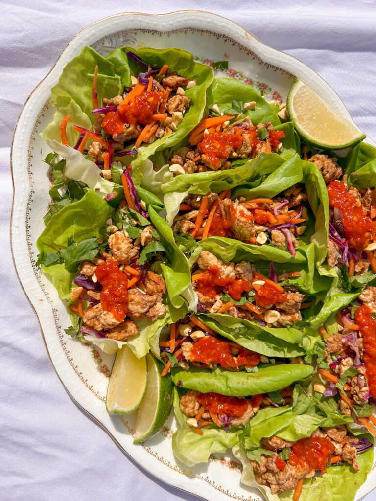 Thai chicken lettuce wraps with peanut flavor, ground chicken, fresh herbs, and lime