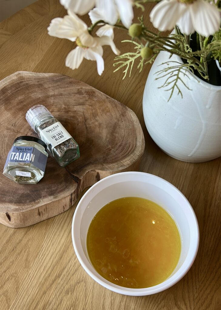 Whisking olive oil, lemon juice, and vinegar for Italian chicken marinade