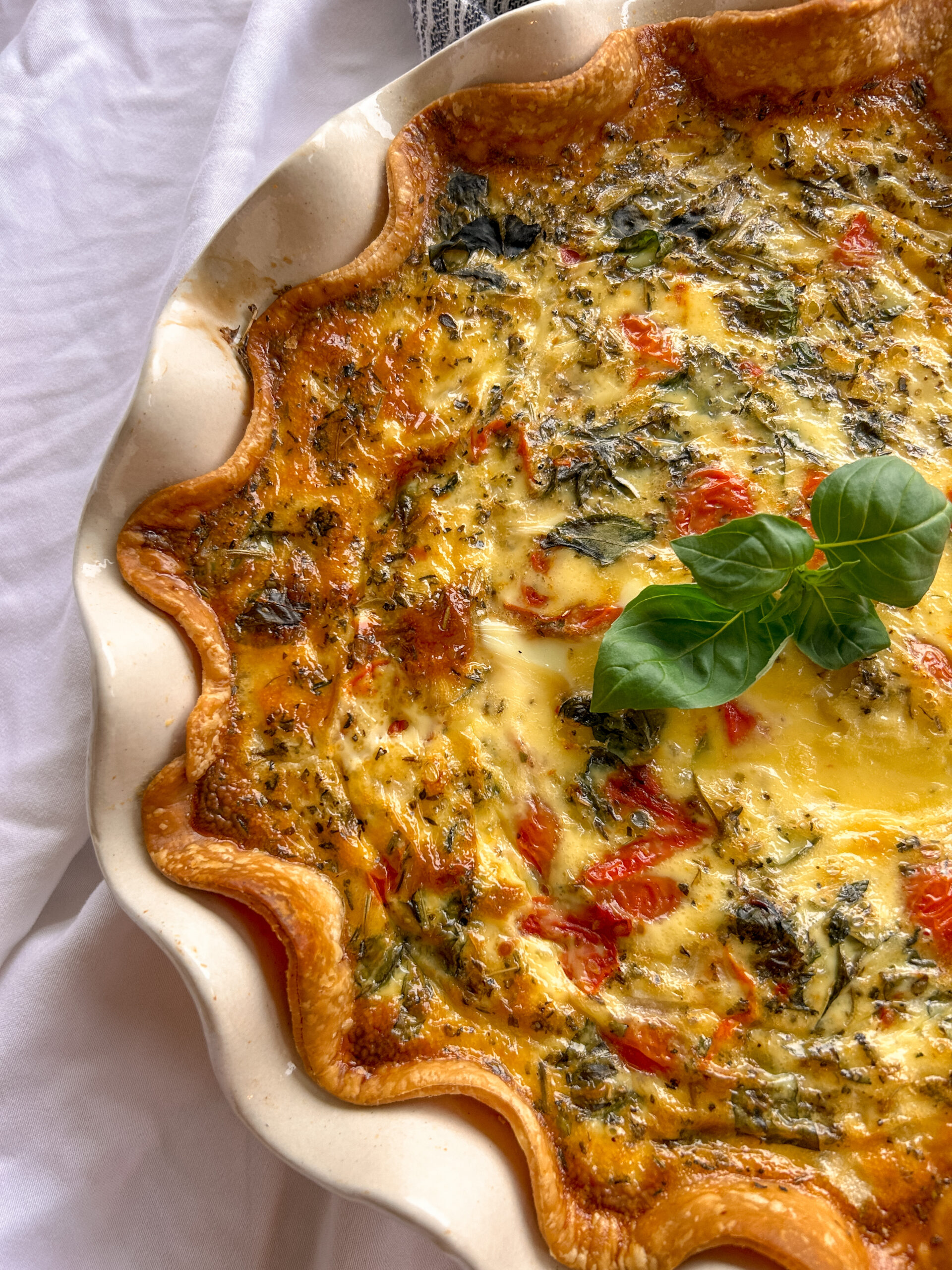 Homemade caprese quiche with basil and mozzarella