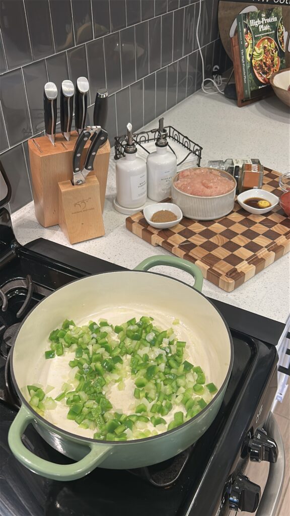 Onion celery and bell pepper cooking for Cajun sloppy joes