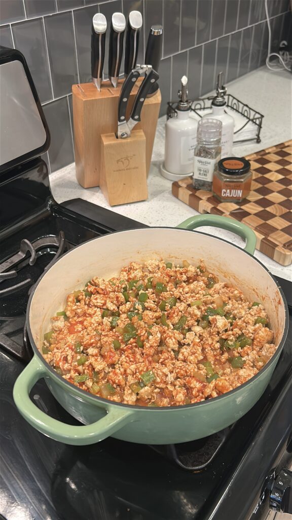 Adding sauce ingredients to Cajun chicken sloppy joes