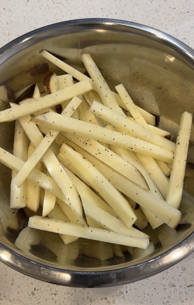 Russet potatoes cut into fries for homemade truffle fries