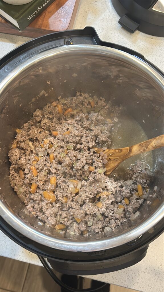 Deglazing the Instant Pot with broth while making Bolognese sauce