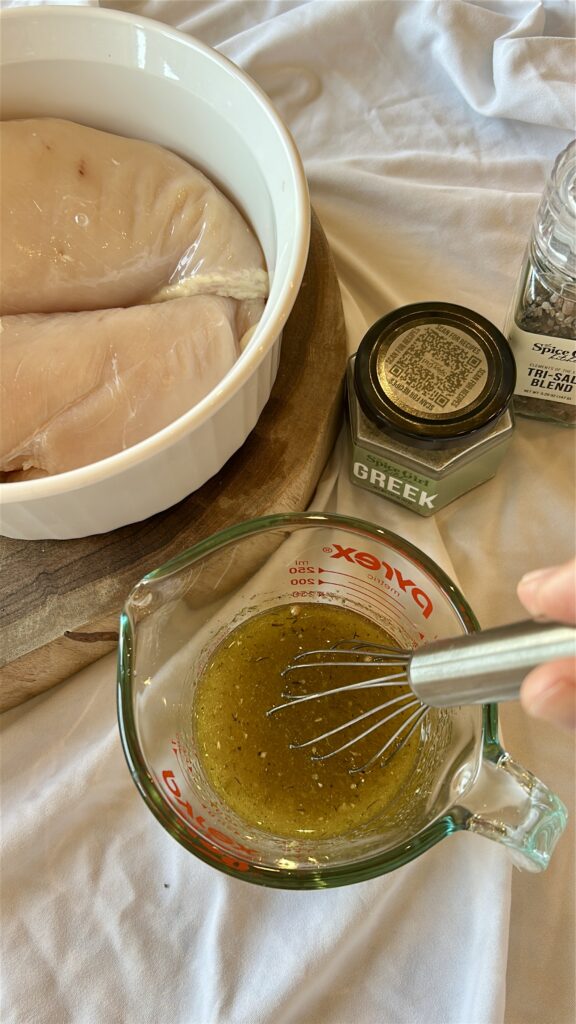 whisking easy greek chicken marinade until combined