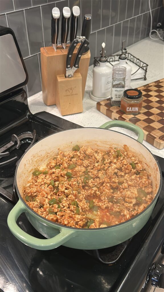 Cajun chicken sloppy joe filling simmering in skillet