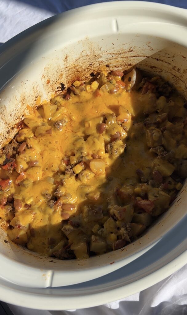 Melted cheddar cheese on top of slow cooker cowboy casserole