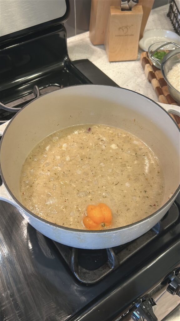 Kidney beans, coconut milk, and seasonings simmering for Jamaican rice and peas