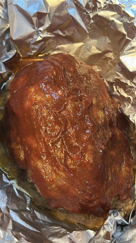 Crockpot meatloaf fully cooked in the slow cooker before the final glaze is added