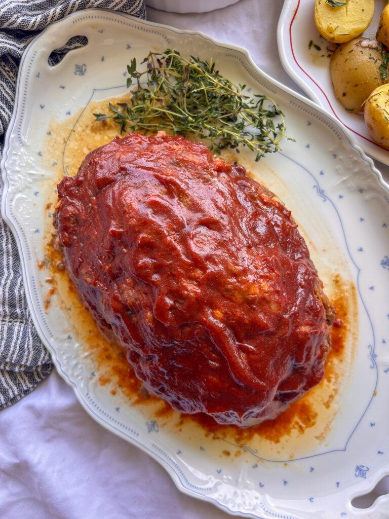 Close-up of tender crockpot meatloaf topped with a sweet and tangy glaze