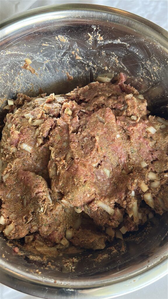 Ground beef, breadcrumbs, seasonings, and other ingredients mixed together for crockpot meatloaf