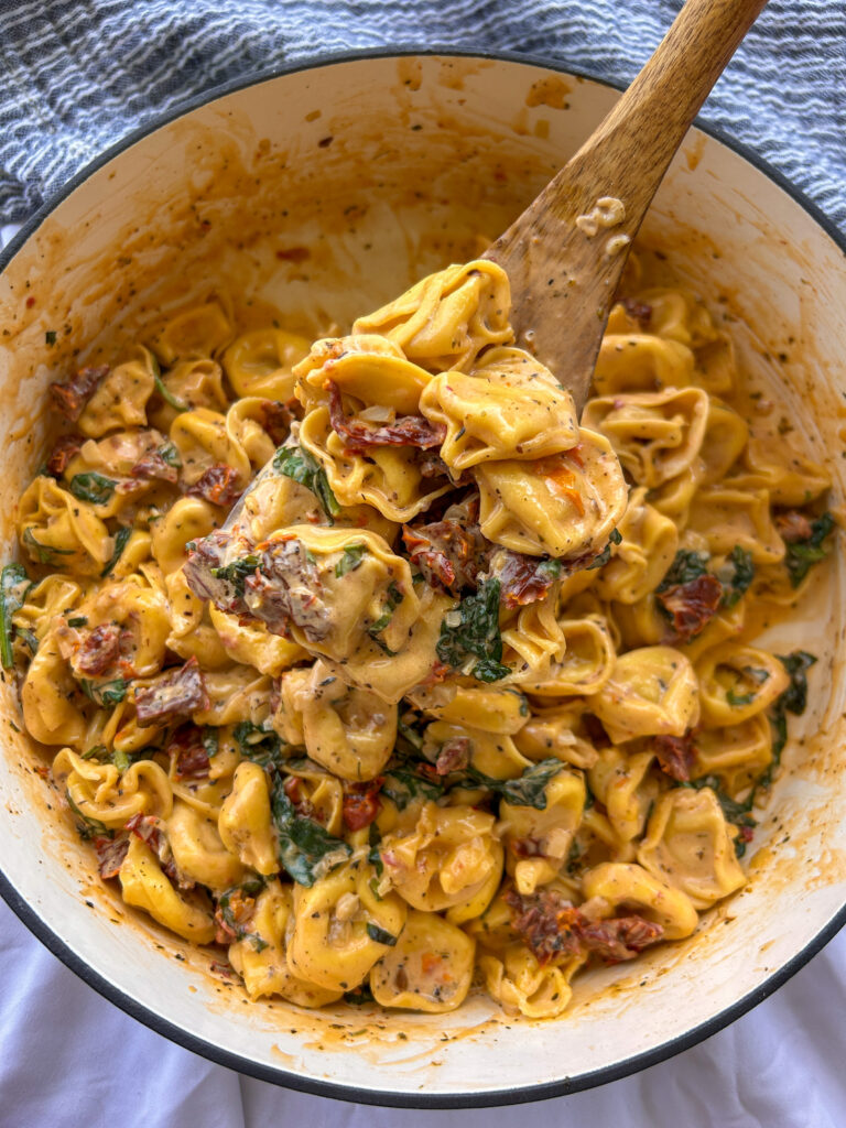 Finished Marry Me Tortellini with spinach, basil, Parmesan cheese, and sun-dried tomatoes ready to serve