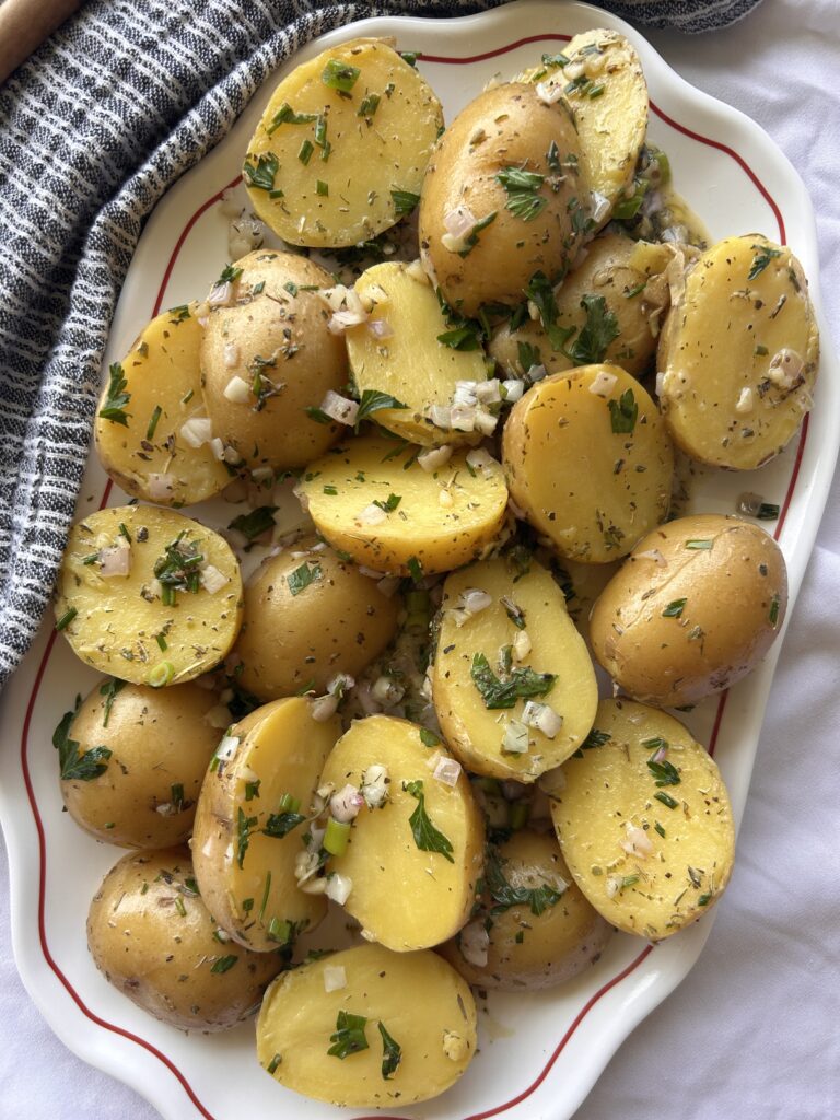 Close up of French potato salad with fresh herbs and Dijon vinaigrette