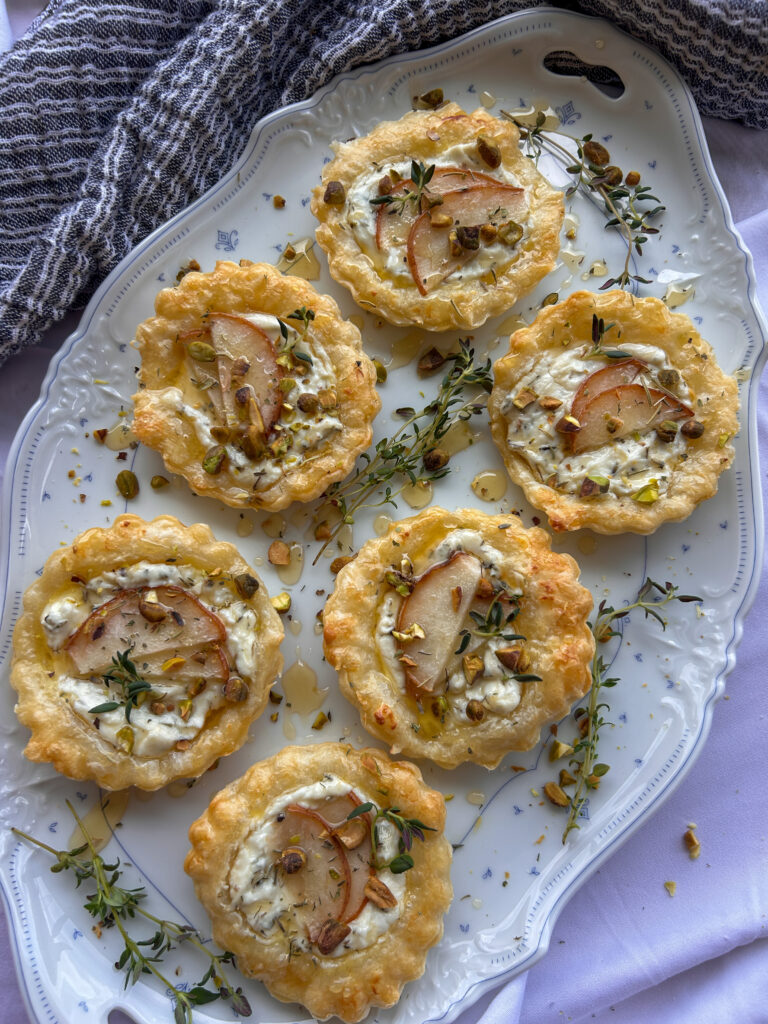 Lavender goat cheese tartlets drizzled with honey and topped with pistachios