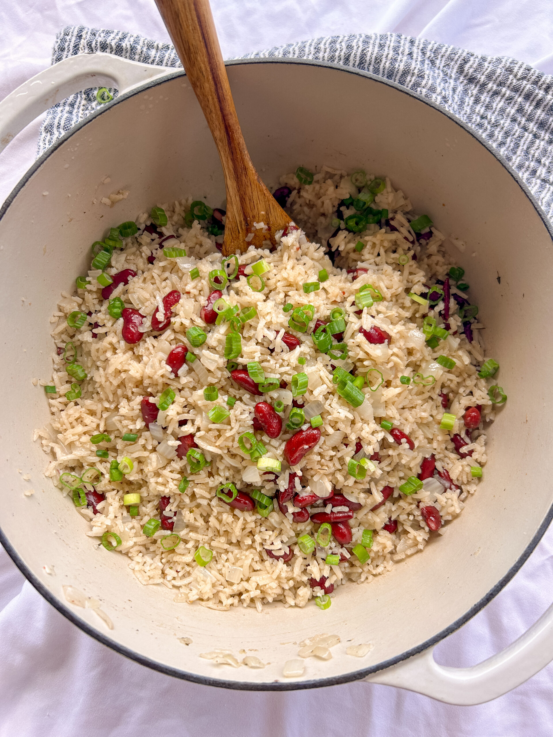 Authentic Jamaican rice and peas served in a bowl with green onions