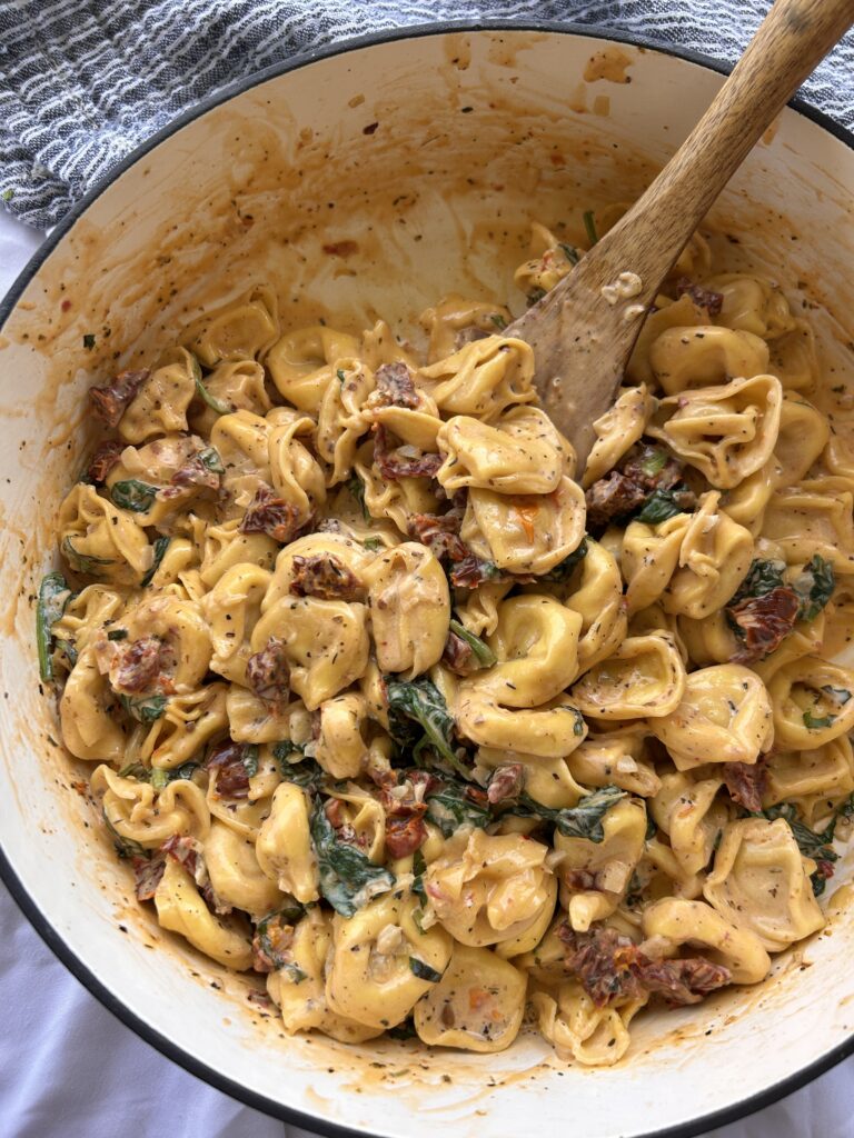 One pot Marry Me Tortellini with creamy Parmesan sauce, sun-dried tomatoes, spinach, and fresh basil