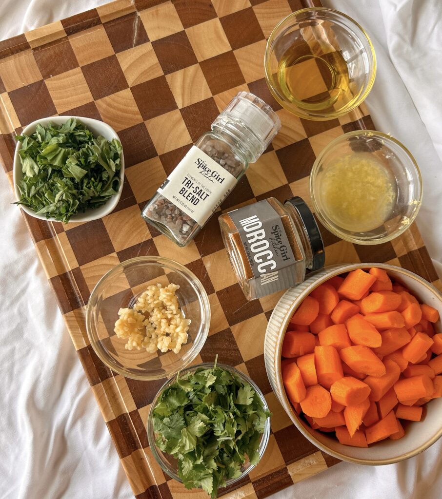 Ingredients for Moroccan carrot salad including carrots, parsley, cilantro, lemon, garlic, olive oil, and Moroccan seasoning
