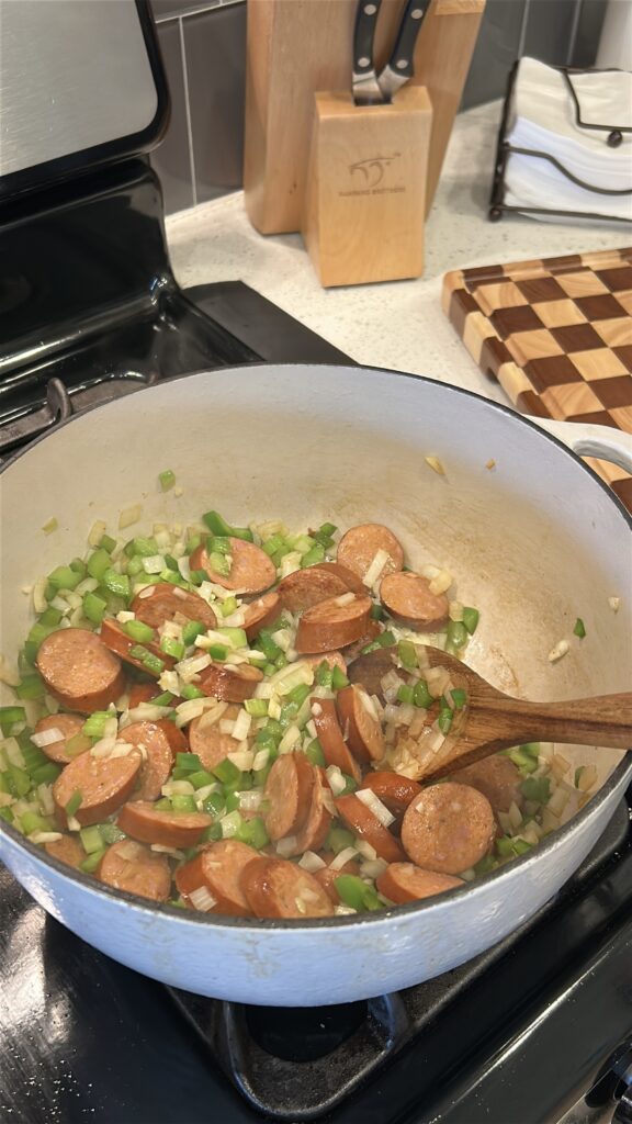 Onion, celery, bell pepper, and garlic cooking for Louisiana style white beans and sausage