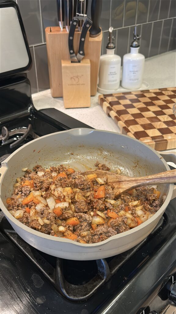 Ground beef mixed with tomato paste and Okie Rub for slow cooker cowboy casserole