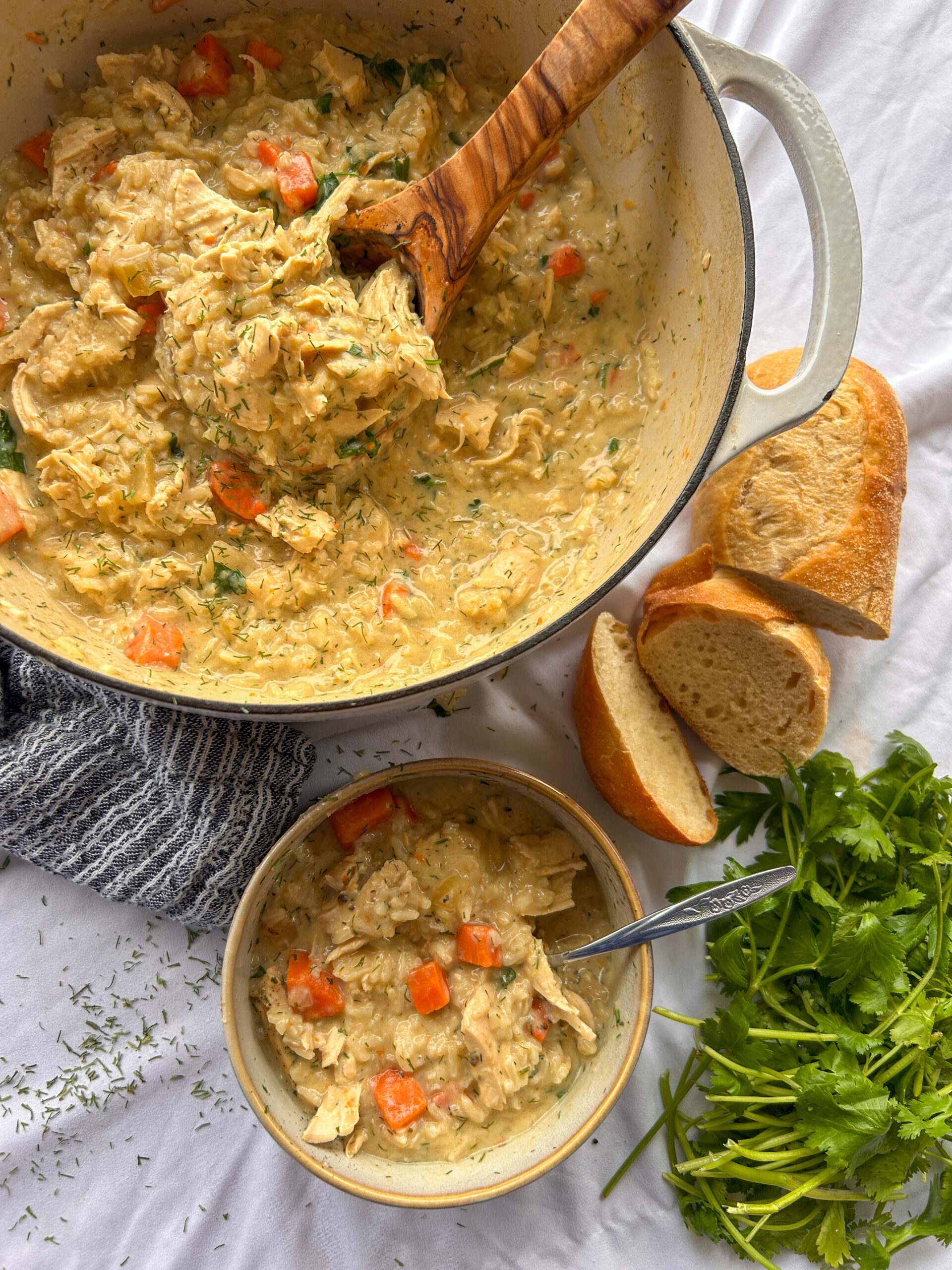 Greek lemon chicken soup (Avgolemono) with shredded chicken, rice, fresh dill, and lemon