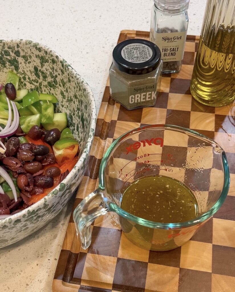 Olive oil, red wine vinegar, lemon juice, and Greek Seasoning whisked together for Traditional Greek Salad dressing