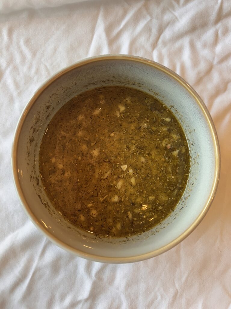 Homemade Greek vinaigrette made with lemon juice, olive oil, garlic, and Greek seasoning