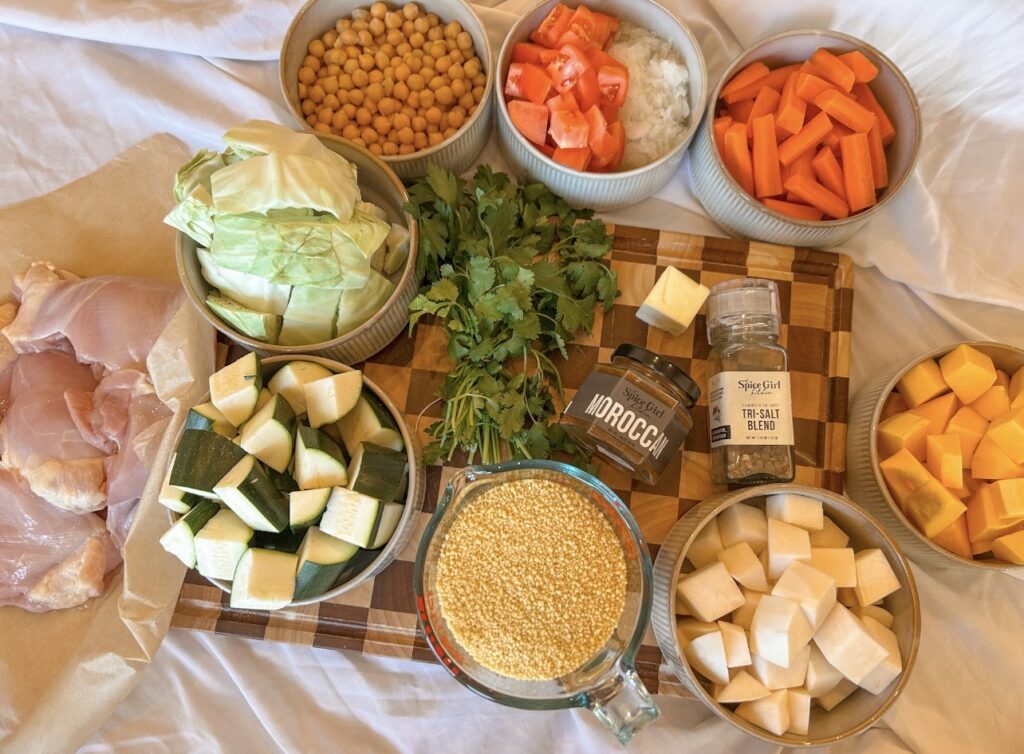 Ingredients for Moroccan couscous with chicken, seven vegetables, chickpeas, fresh herbs, and Moroccan seasoning