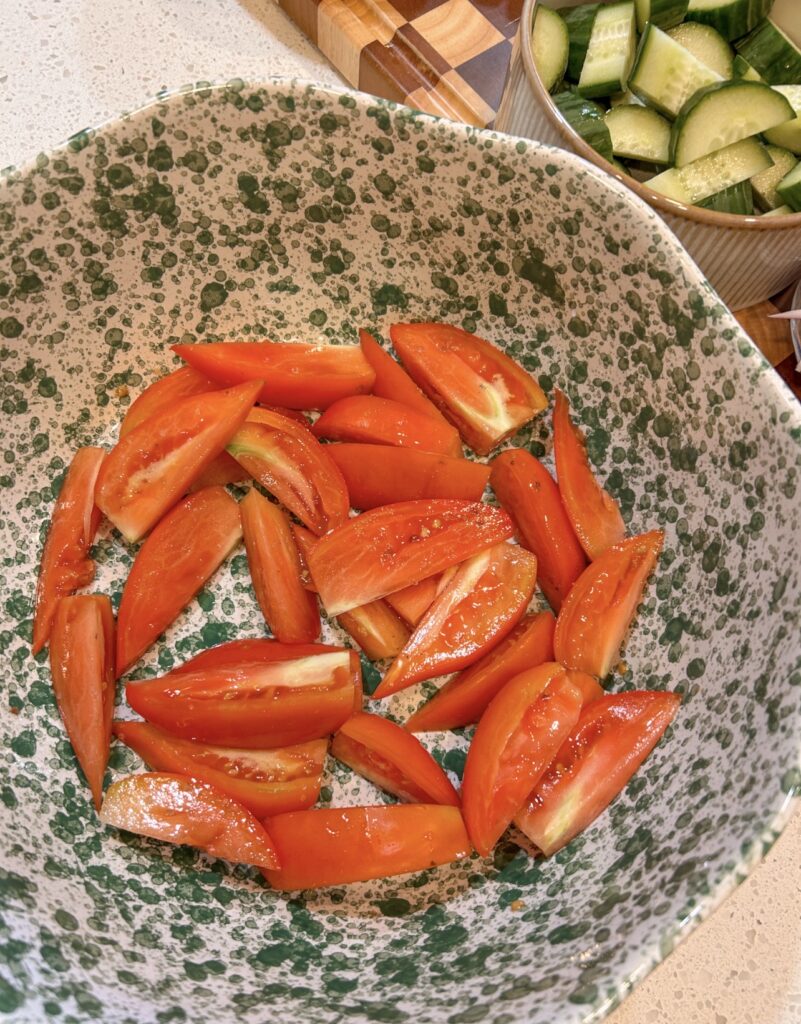 Roma tomato wedges resting with salt before making Traditional Greek Salad