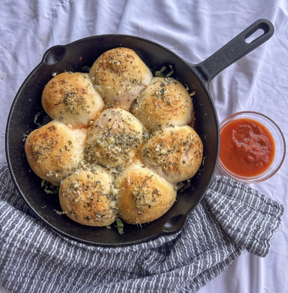 Cheesy pepperoni pizza bombs served warm with marinara sauce for dipping.