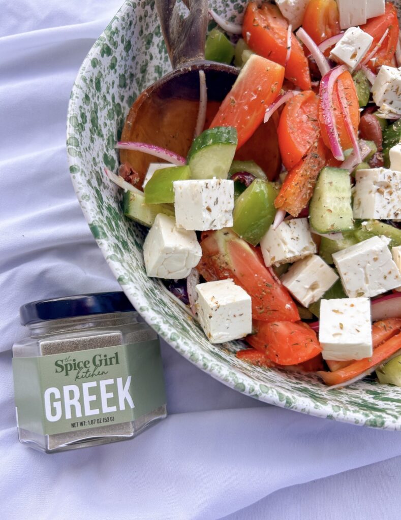 Finished Traditional Greek Salad garnished with Greek Seasoning and ready to serve