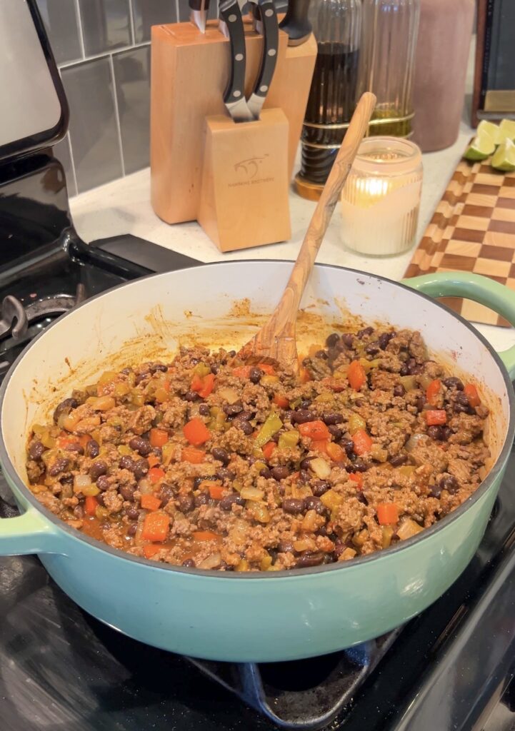 Seasoned ground beef filling with black beans, bell peppers, onions, and green chiles for sheet pan nachos