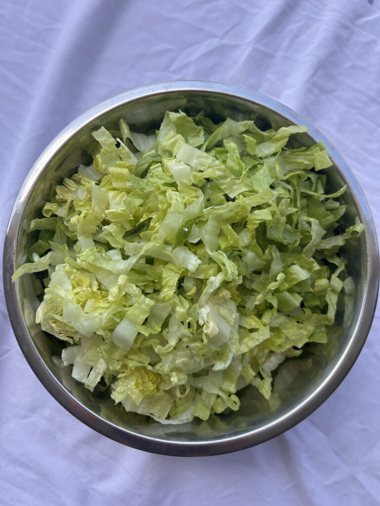 Thinly sliced romaine lettuce prepared for authentic Greek lettuce salad