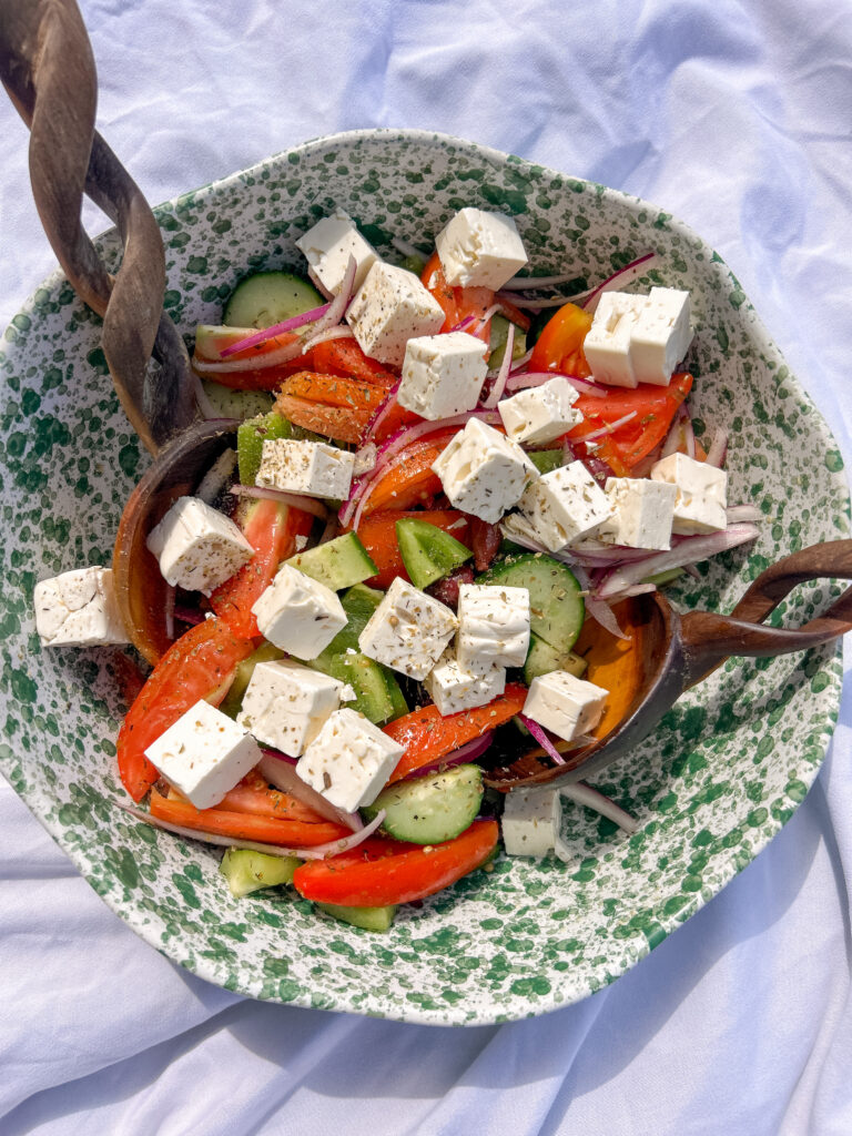 Traditional Greek Salad (Horiatiki) made with tomatoes, cucumber, Kalamata olives, block feta, and olive oil