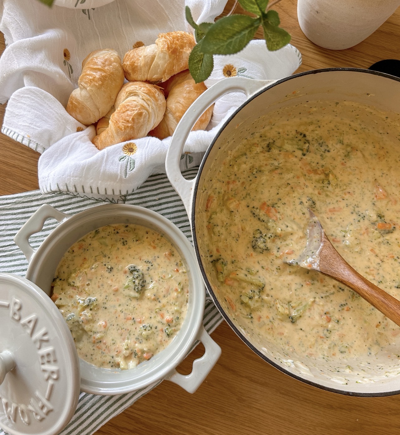 Freshly grated sharp cheddar being stirred into broccoli cheddar soup